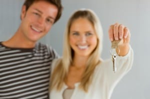 couple holding the keys to their first home